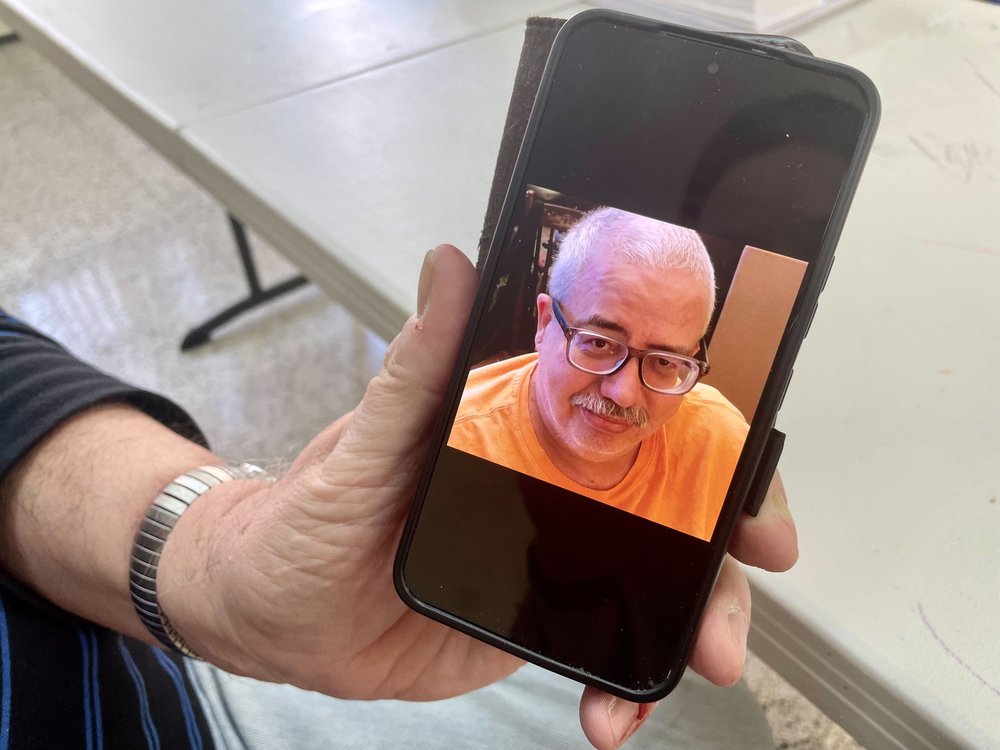 Ed Koenig holds his favorite photograph of his husband, Jody Settle, taken before Settle died of Covid in April 2020.