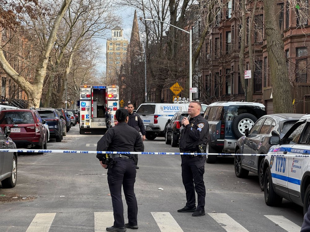 Police gather around a home on St. John's Place in Park Slope Saturday afternoon.