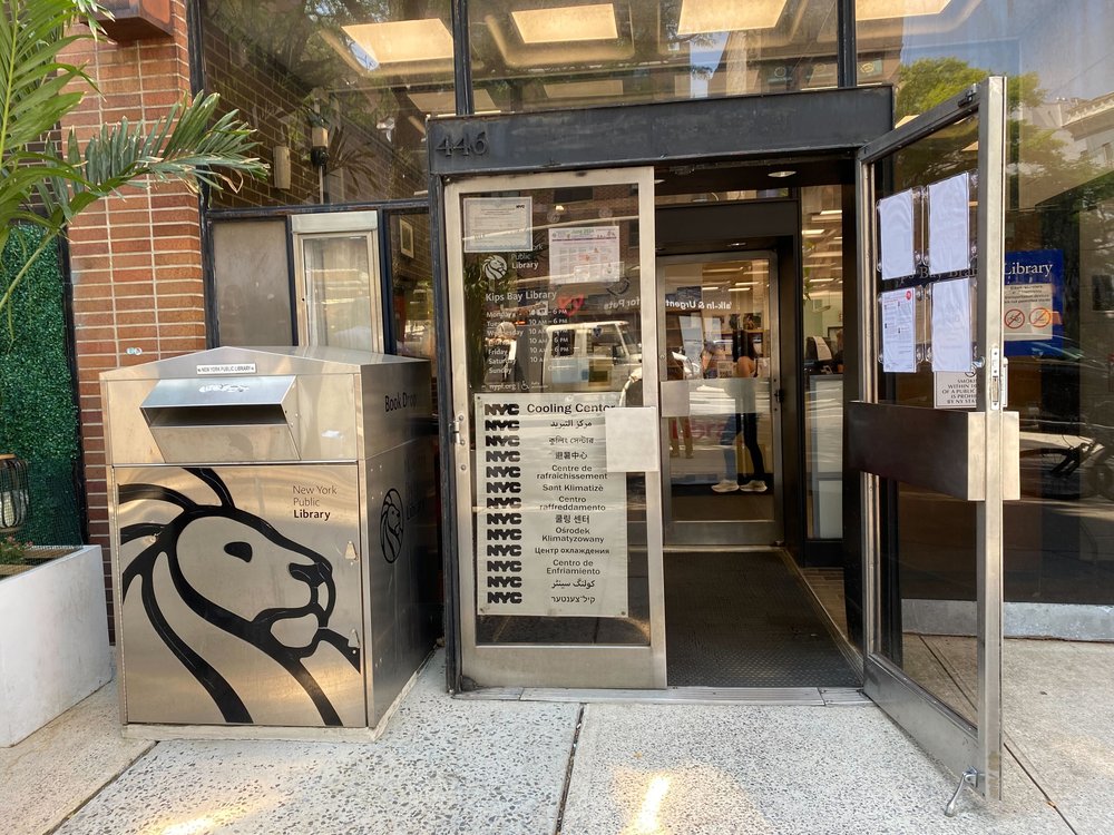 The exterior of the Kips Bay library branch, with signage noting that it's a cooling center.