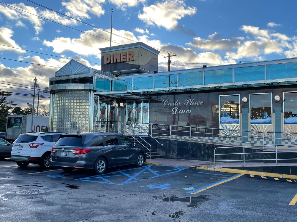 Outside of the Carle Place Diner, a largely chrome restaurant with glass bricks.