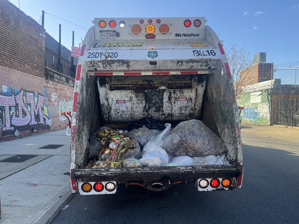 A sanitation truck full of compost.