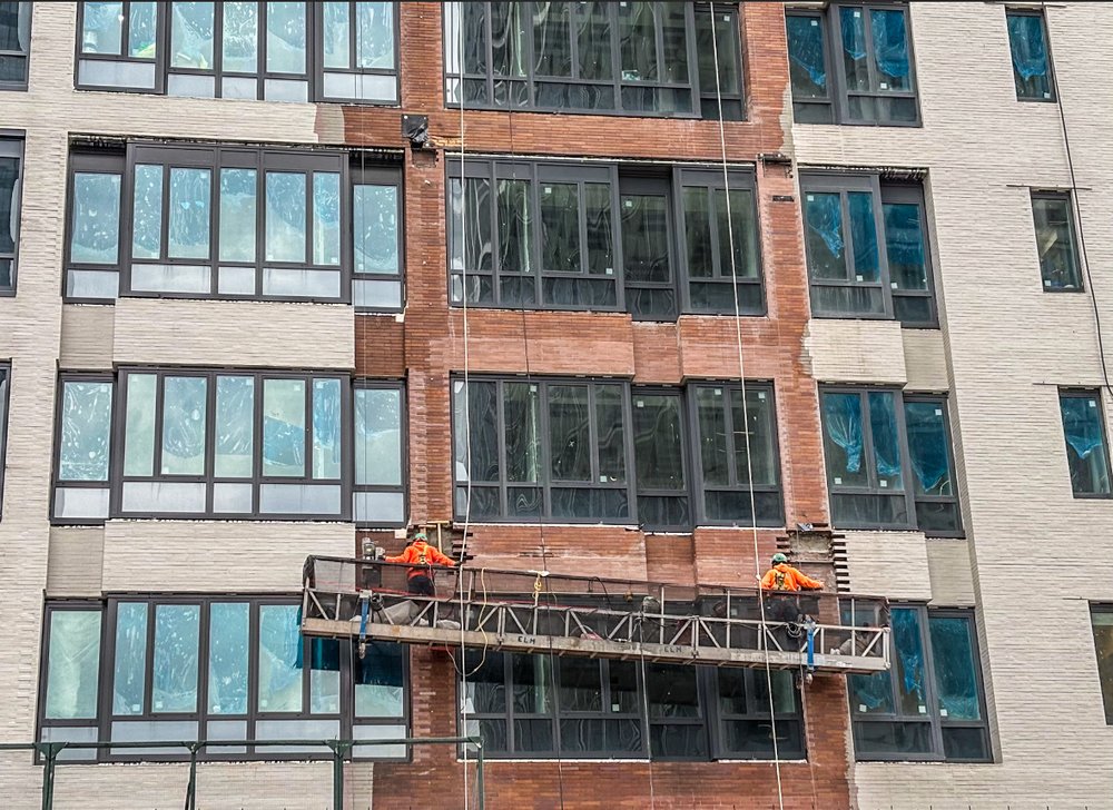 Construction workers in front of 25 Water St.