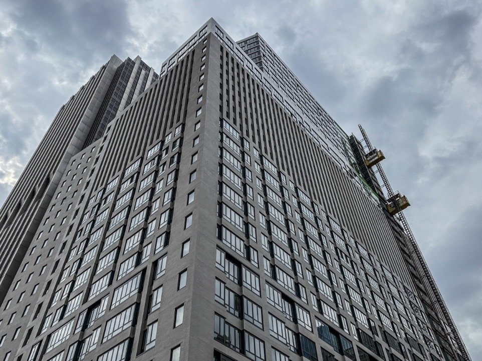 A look upward at a large, window-covered building at 25 Water St.