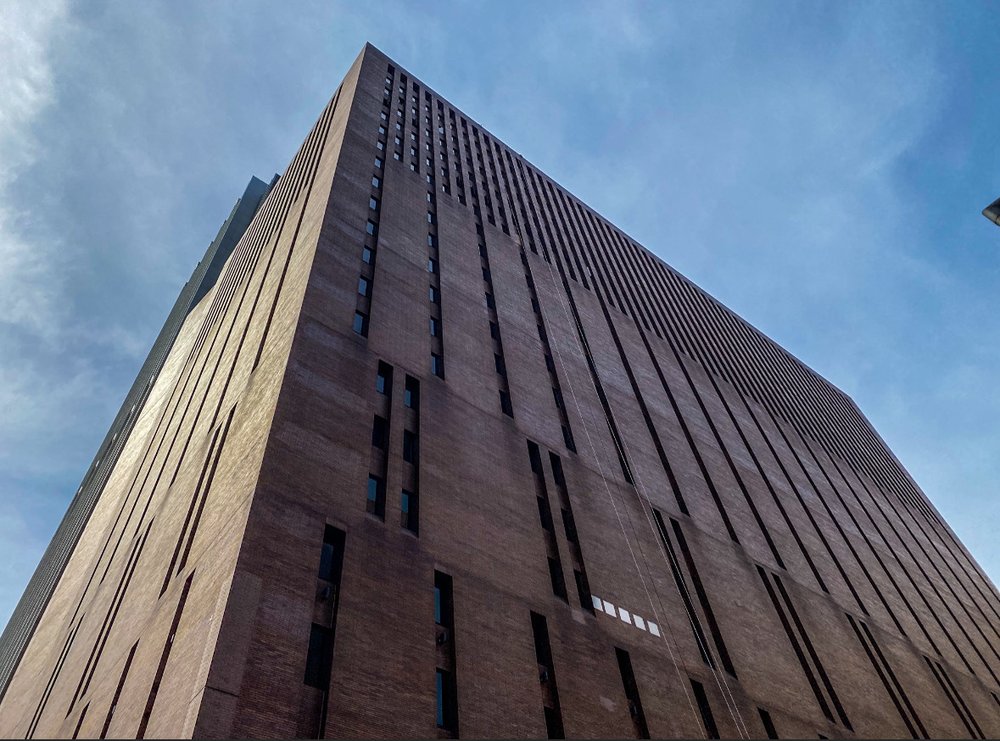 The facade of 25 Water St. as it looked in April 2023, with its unique, computer punchcard-inspired design.