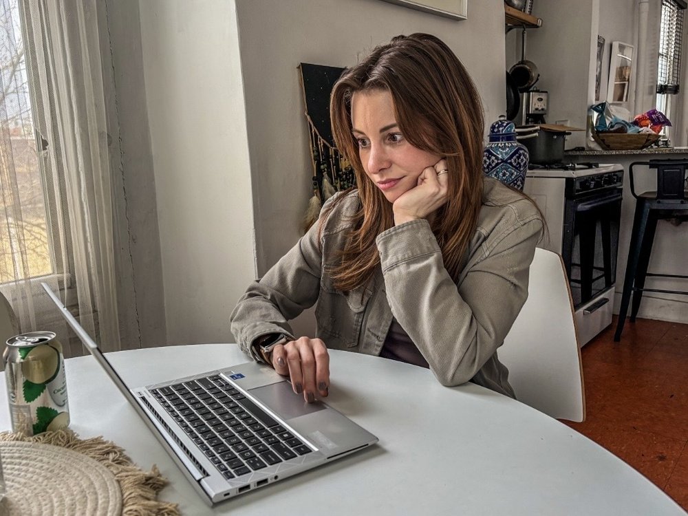 A woman looking at a computer.