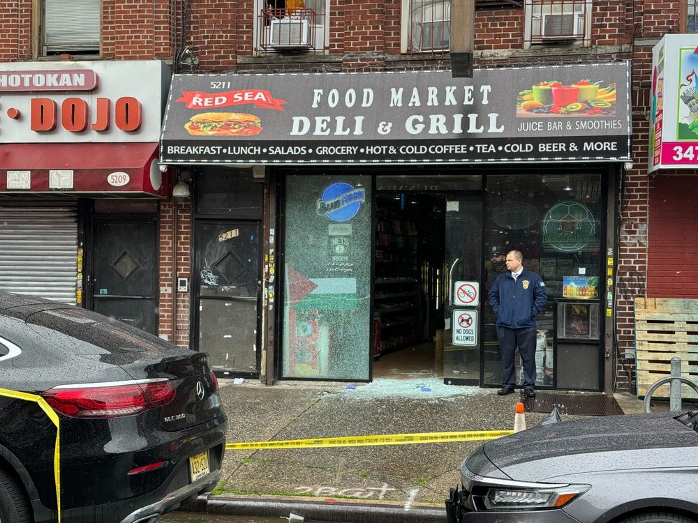 A deli in Brooklyn with a busted door.