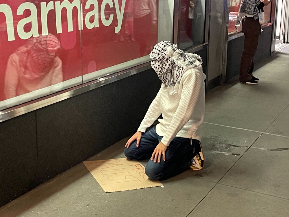 A man kneels to pray.