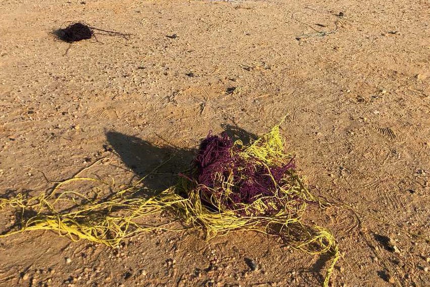 A jumble of red and yellow string outside.