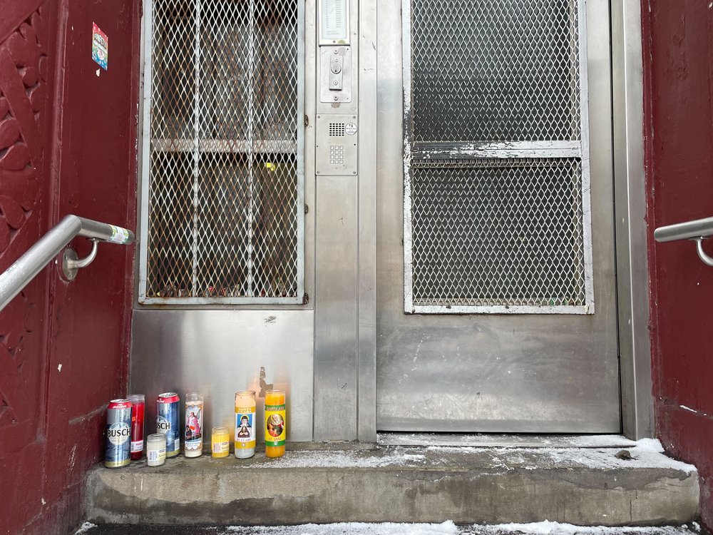 Memorial candles stand outside Richard Henderson's building in Crown Heights, Brooklyn, on Jan. 16, 2024.