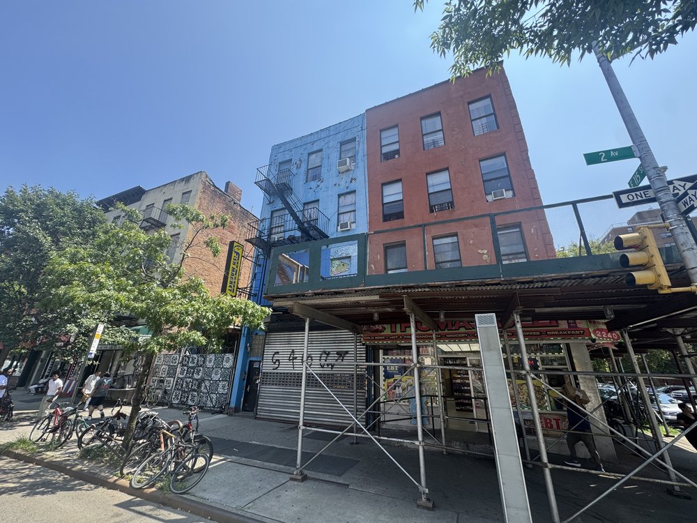 A blue builiding with a mural of fishes in East Harlem.