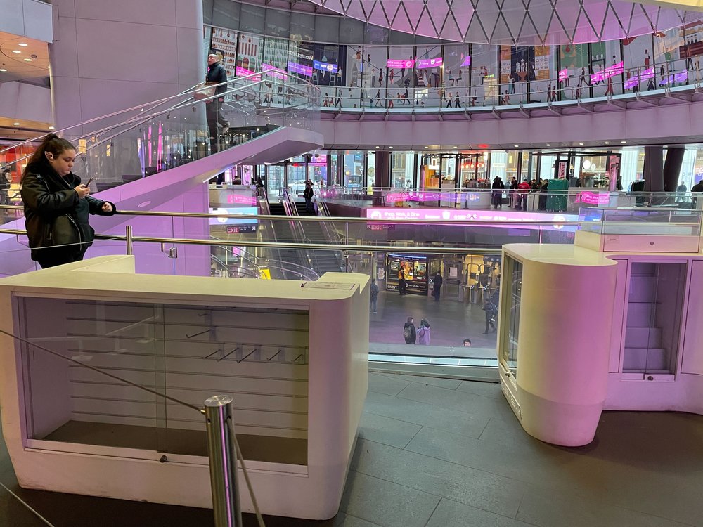Empty kiosks at the Fulton Transit Center retail hub.