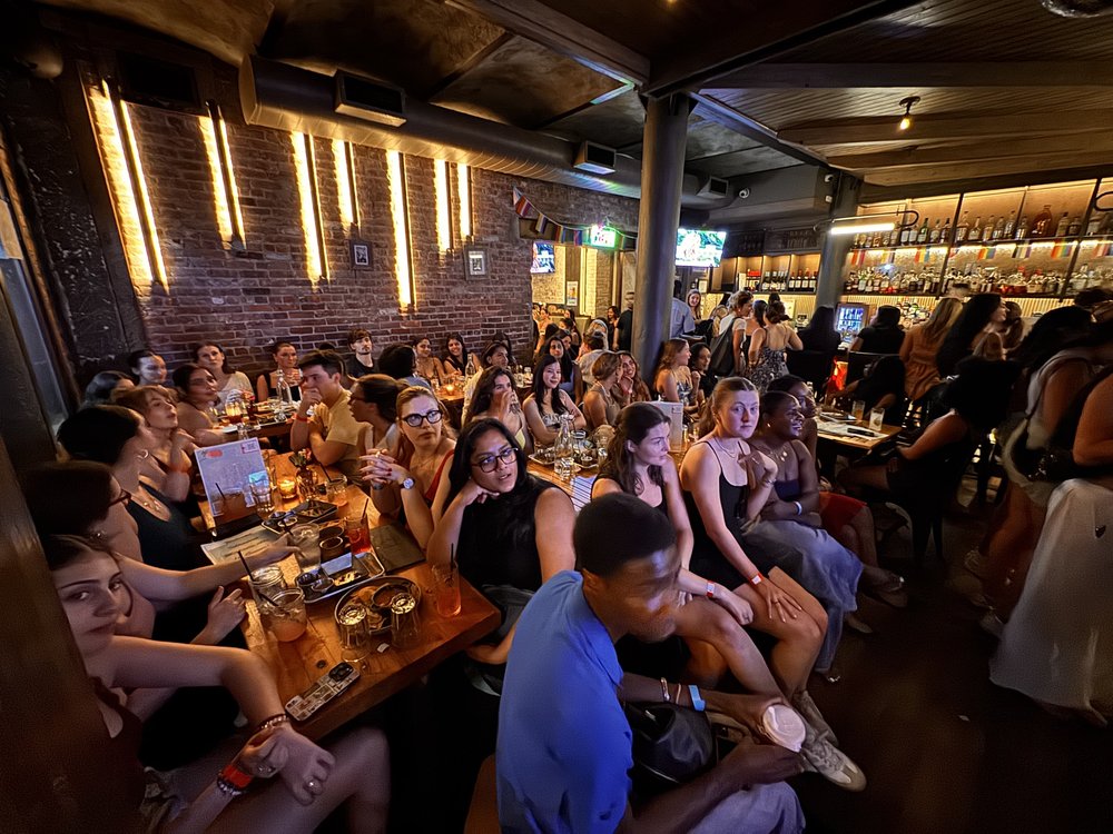 A crowd of people at a New York City bar for a "Love Island" watch party