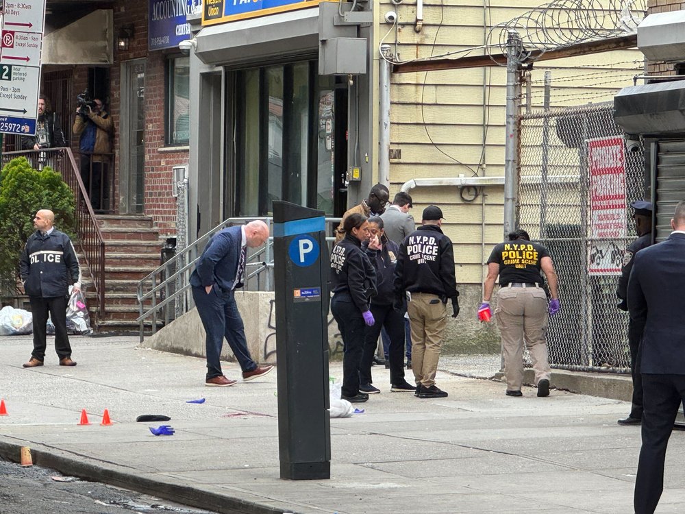 NYPD personnel investigate a police shooting in Astoria on April 14, 2025.