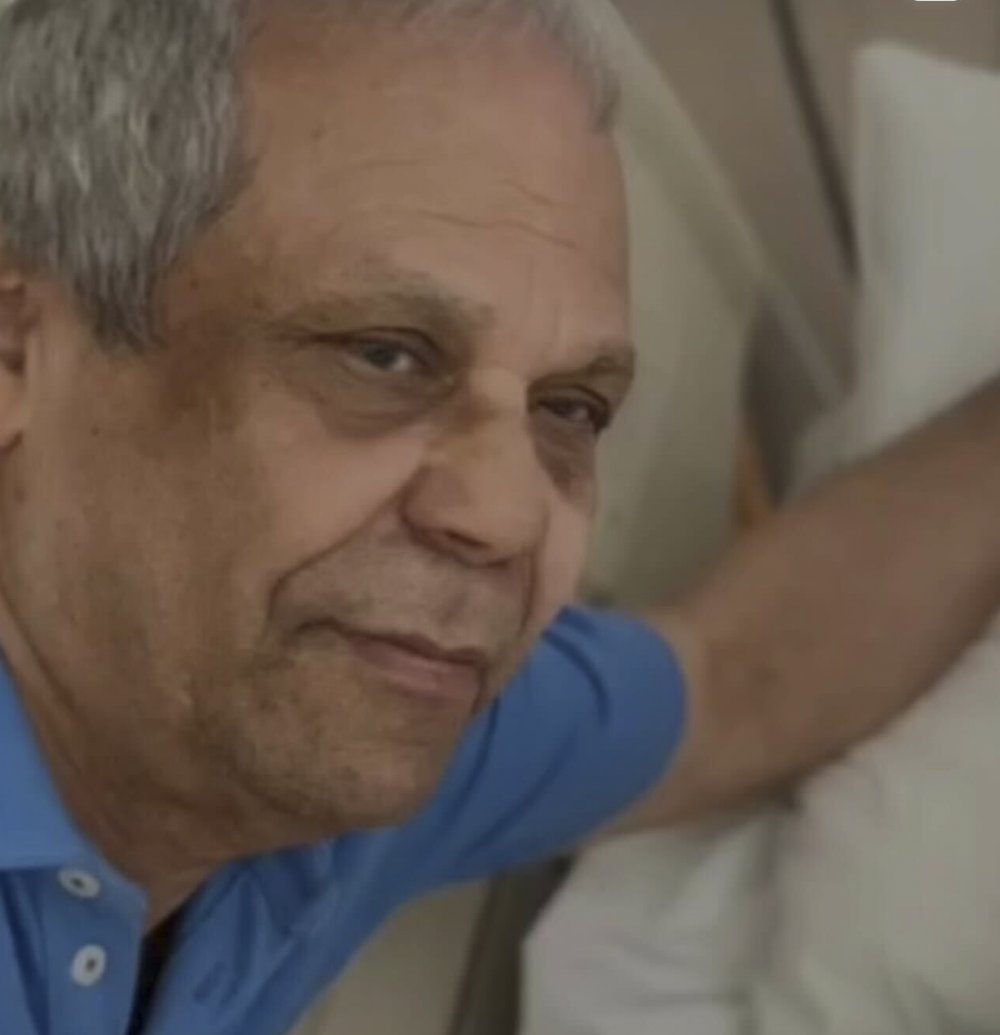 A man with white and gray hair.