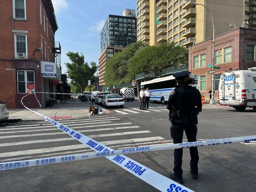 Police tape on a Brooklyn street surrounds a crime. Things are not going well.