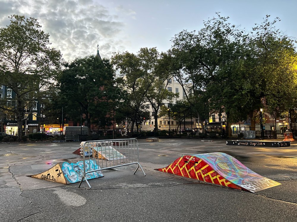 A collection of ramps, boxes, and other objects brought by skaters to the multipurpose court in Tompkins Square Park.