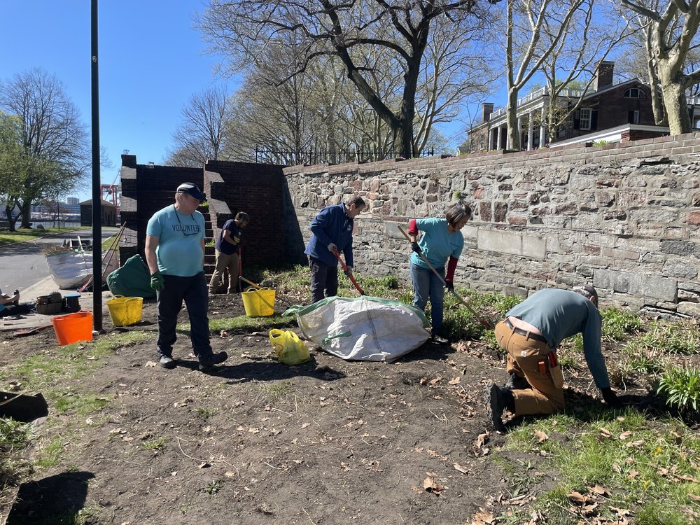 Governors Island staff and volunteers working in a garden.