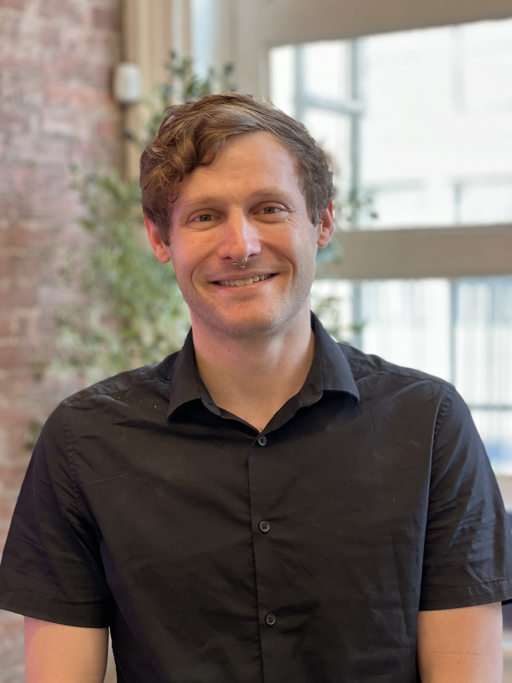 A profile of a man wearing a black shirt