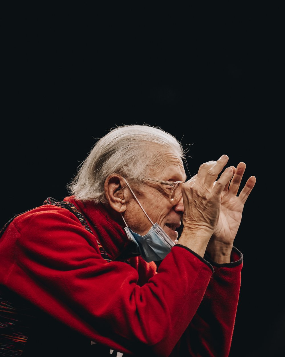 A profile portrait of basketball fan making a distracting gesture during a basketball game.