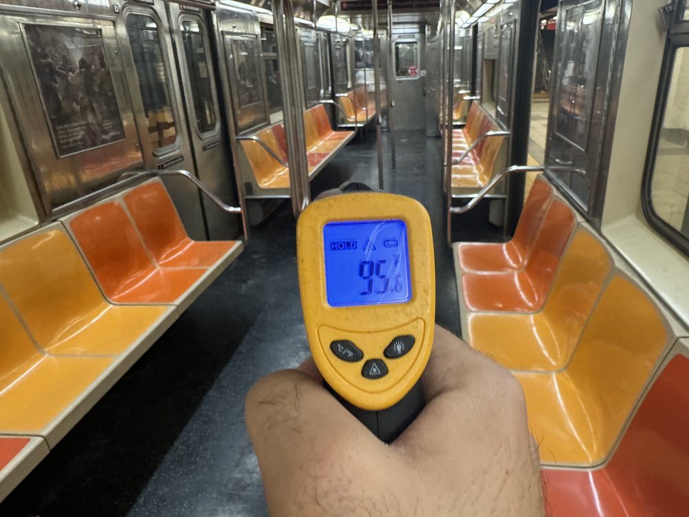 A thermometer showing a 95 degree temperature on a 1 train car.