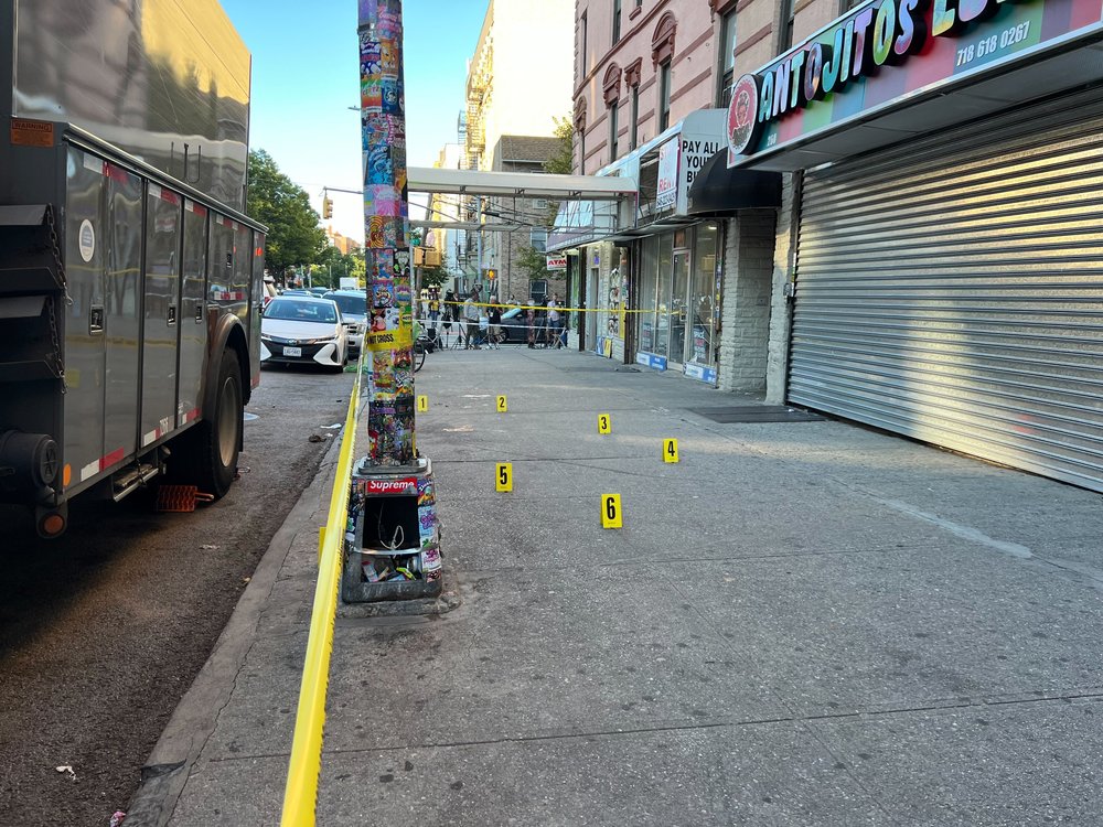 Police section off an area near where they say a 71-year-old woman was shot and killed in the Bronx on Thursday.