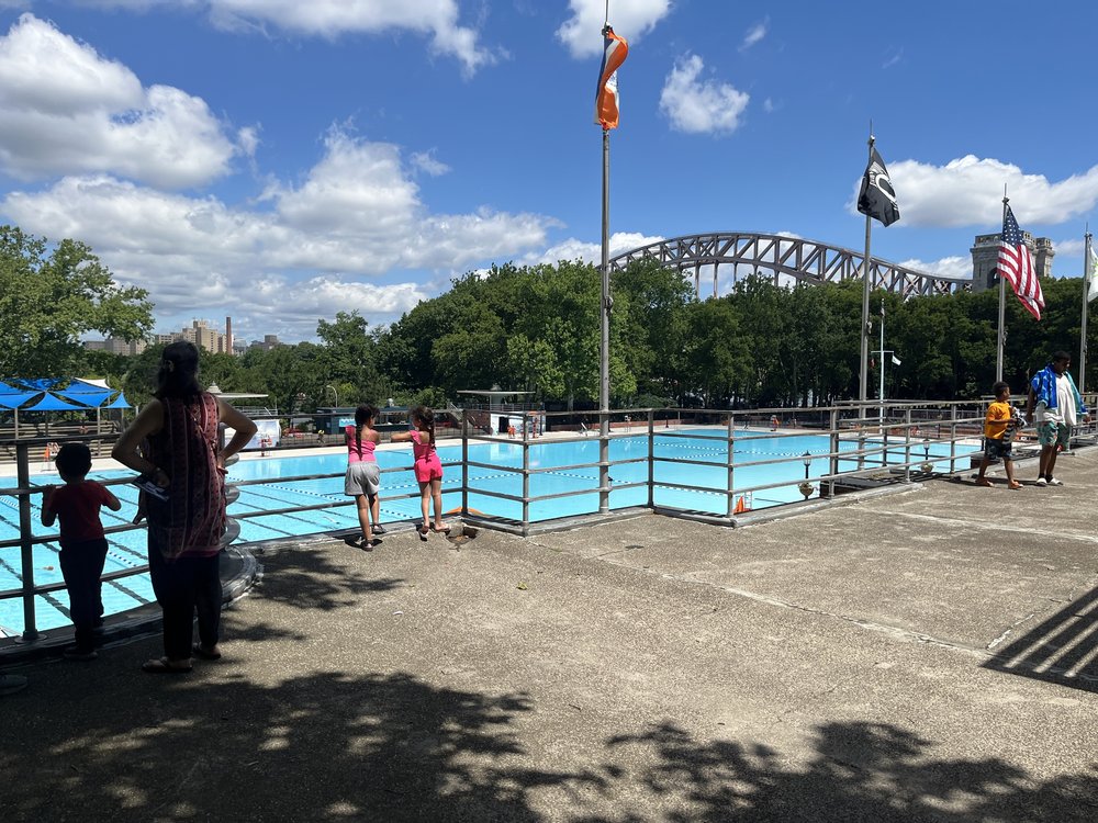 A family looking out upon the Astoria Pool in Queens.