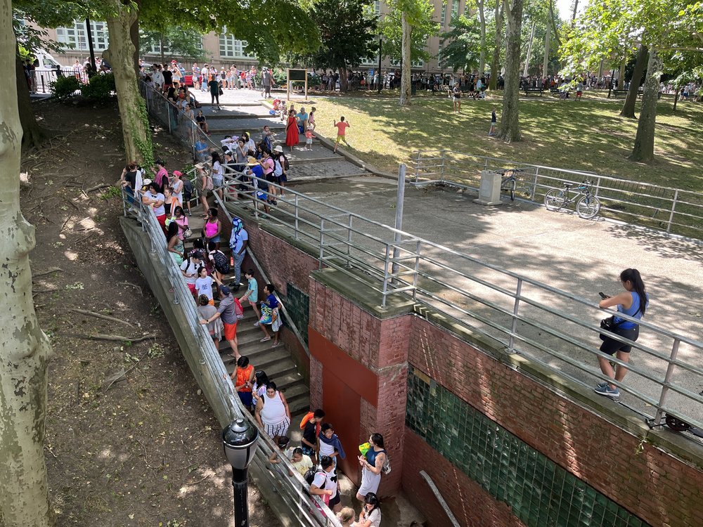 A line snaking around the outside of Astoria Pool in Queens, where there weren't enough lifeguards to open the full water.