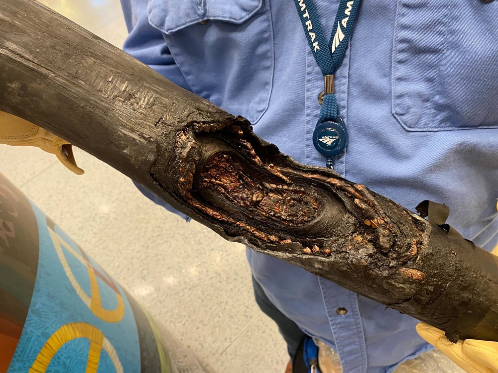 An Amtrak employee shows a cable from the North River Tunnel that exploded after coming in contact with water.