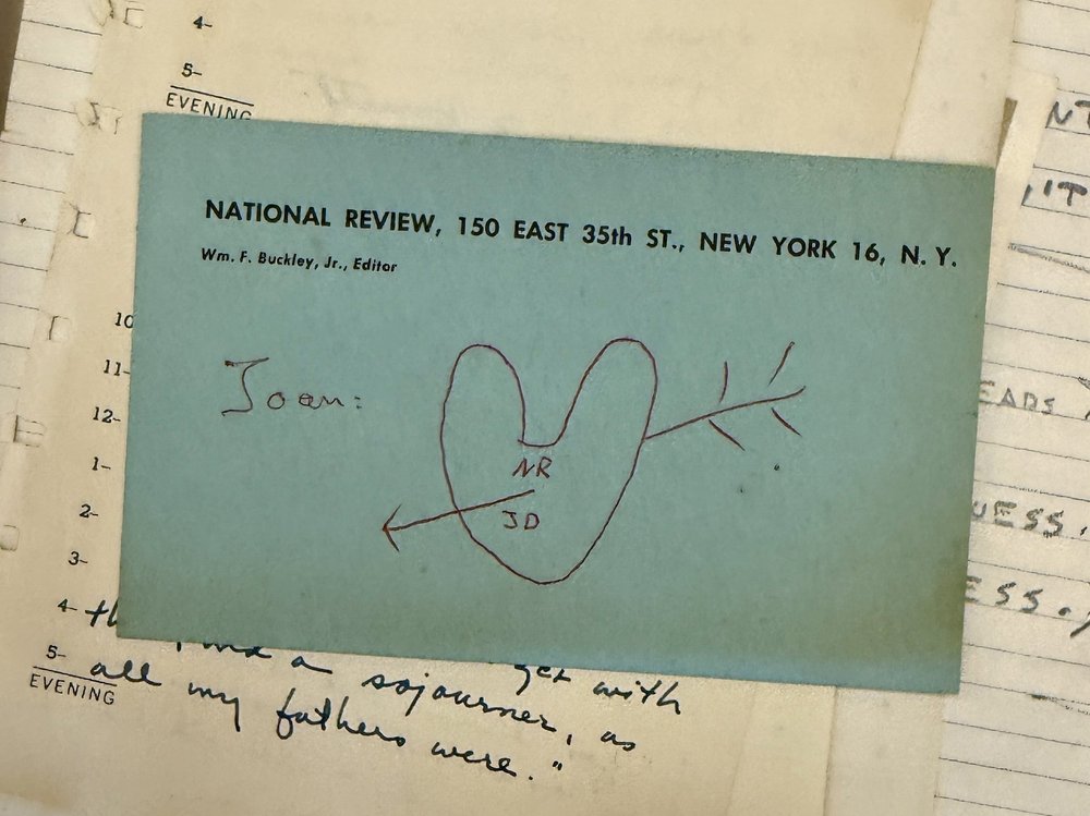 A green card with a heart drawn on it with an arrow through it.
