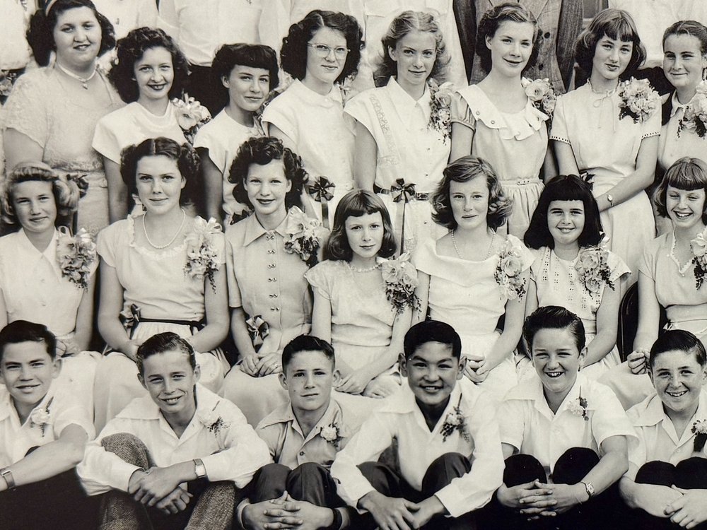 A yearbook photo featuring young girls in white dresses in a black and white photograph.