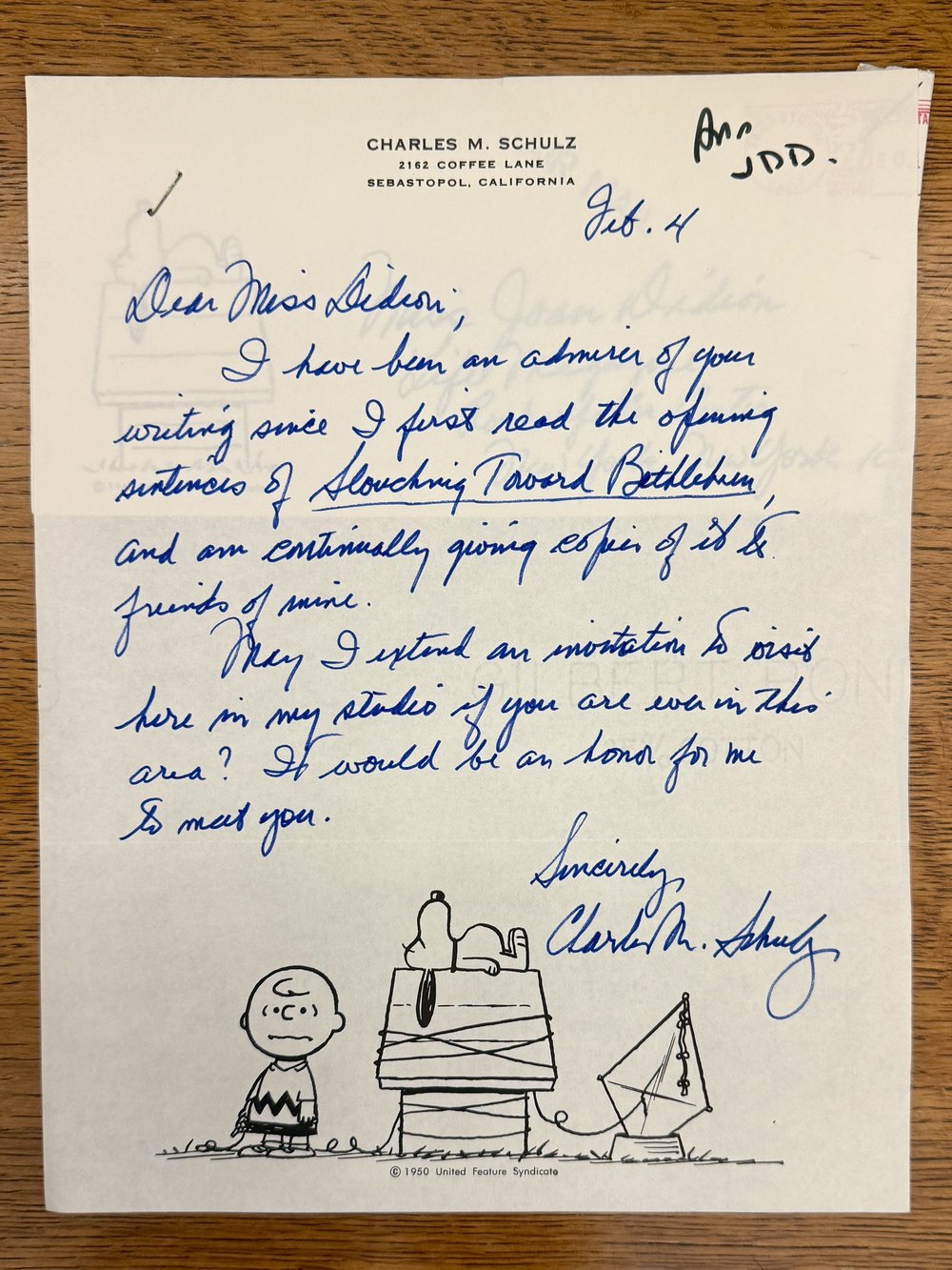 A handwritten letter with a drawing of Snoopy and Charlie Bown on it.