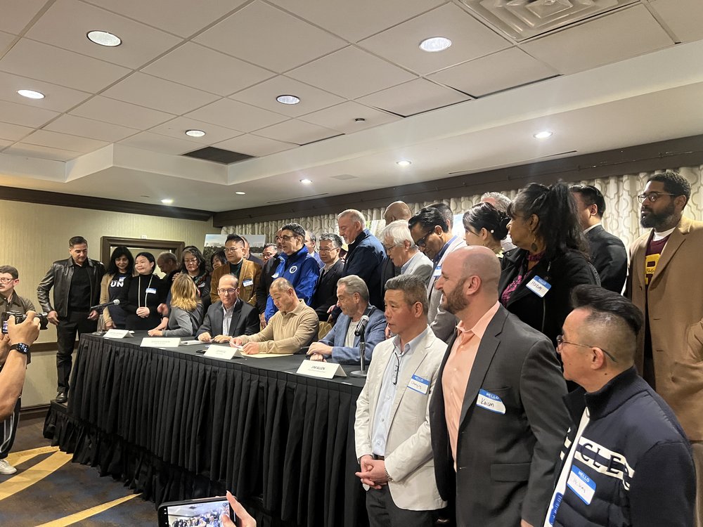 State Sen. John Liu, center, addresses media on Sunday, March 30, 2025.