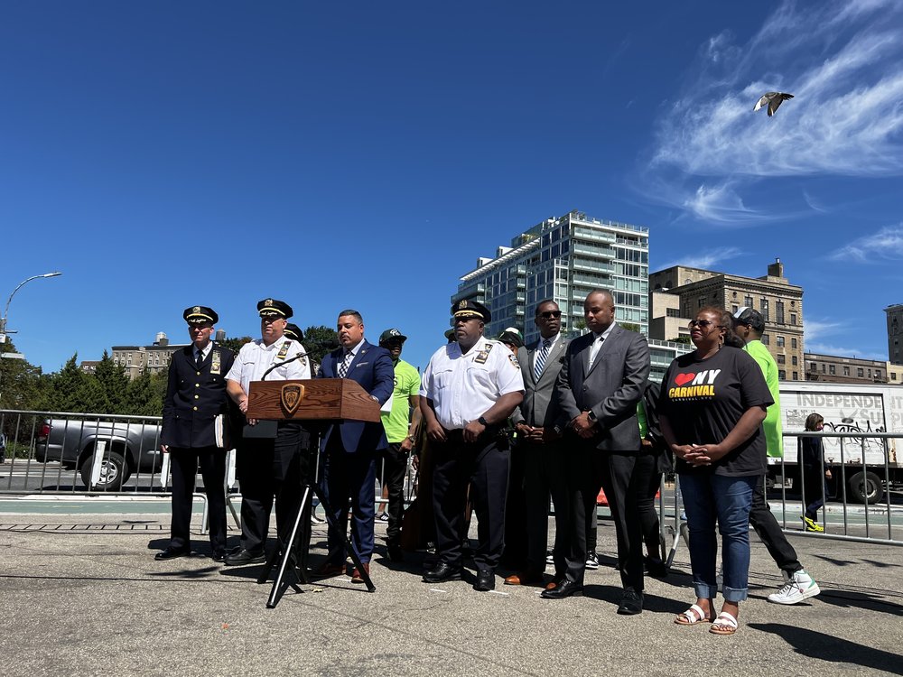 Police speak to reporters at Grand Army Plaza in Brooklyn.