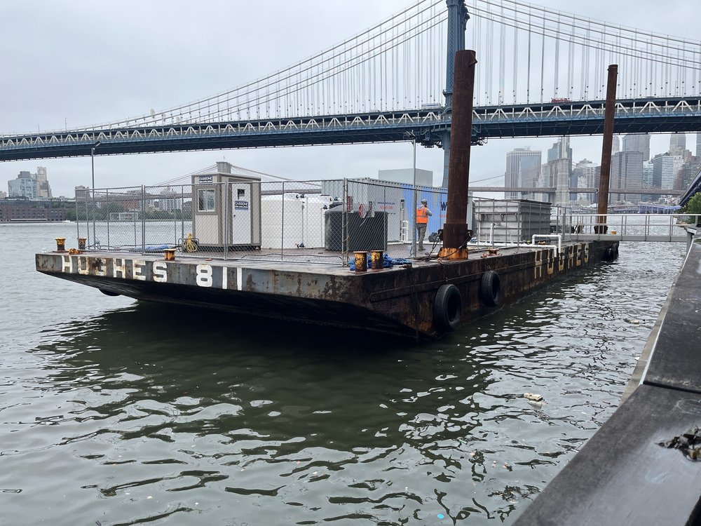 A barge on the East River carrying filter equipment.