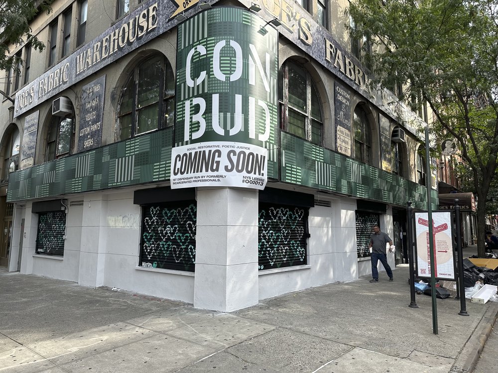 A green and white storefront named, prominently, "Con Bud."