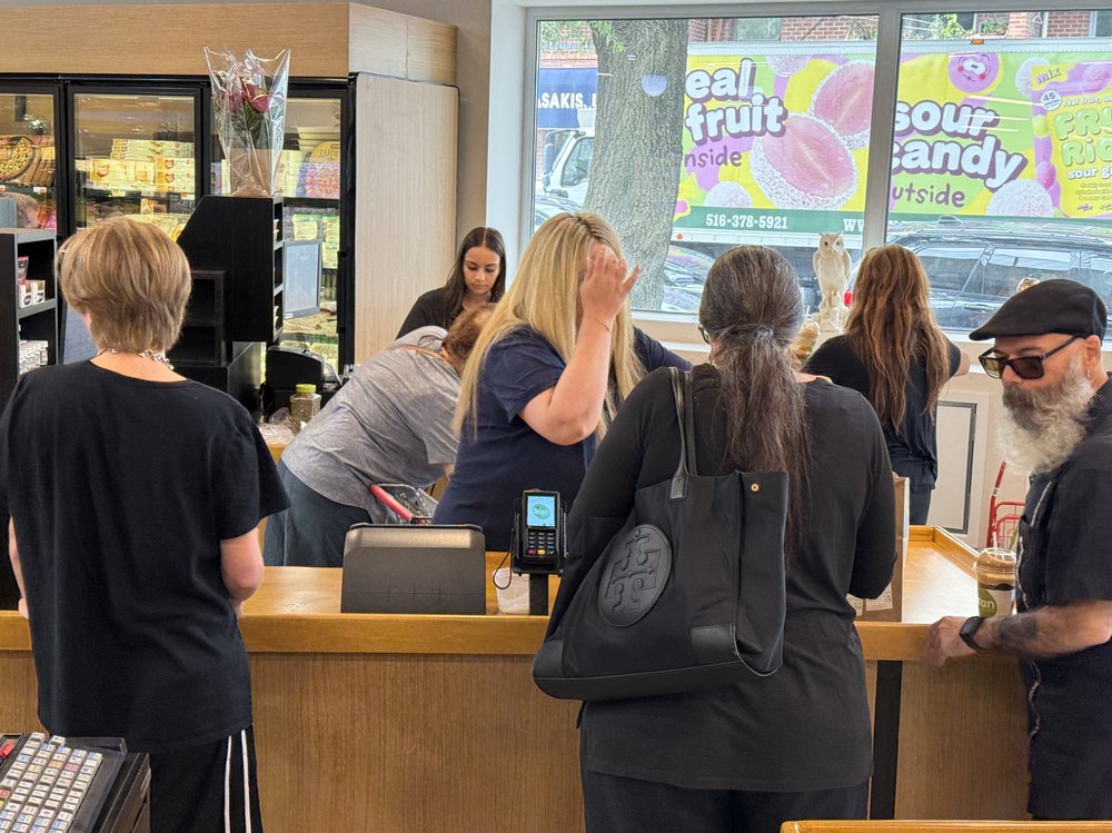 A busy crowd of shoppers at a Greek grocer.