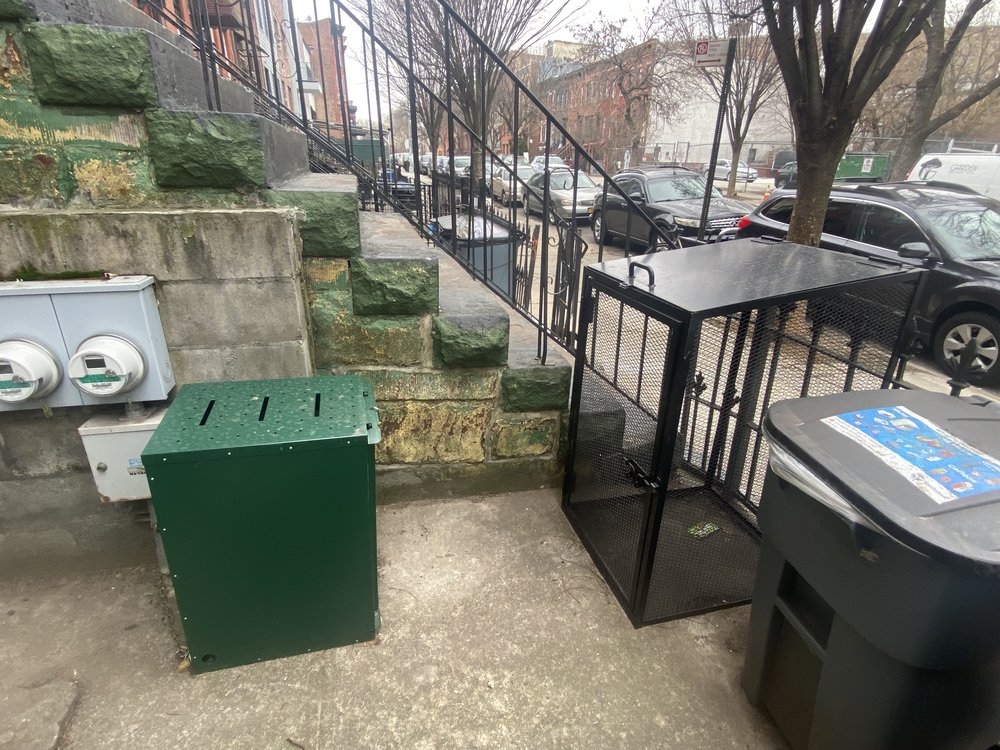 A green box in front of a Brooklyn townhouse.