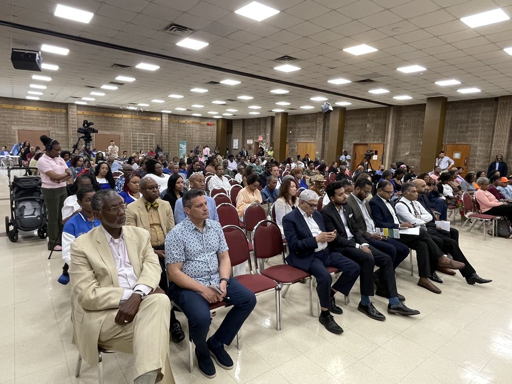 A crowd of voters at a community forum.