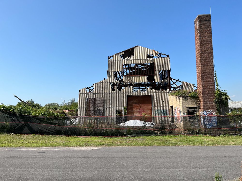 An abandoned, burned building on a clear day.