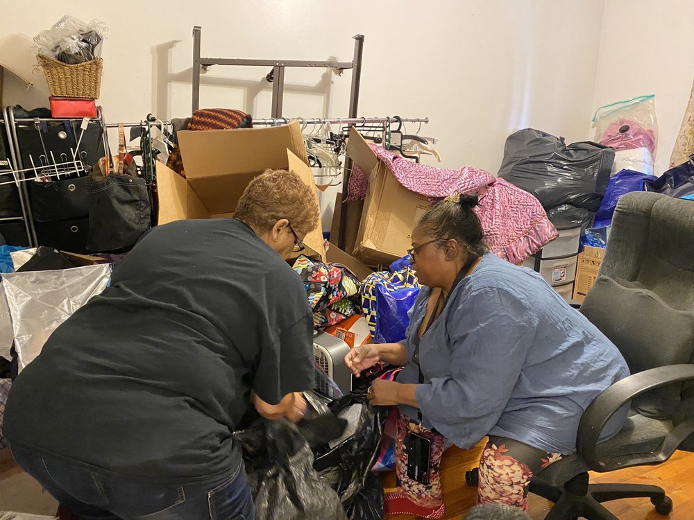 Baird and a friend go through her belongings, deciding which to pack and what can be thrown away.