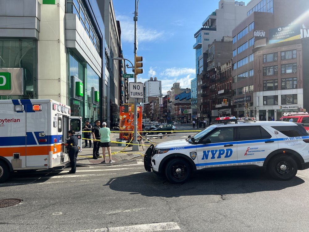 A photo of police inspecting the scene of a crash that killed 2 people.