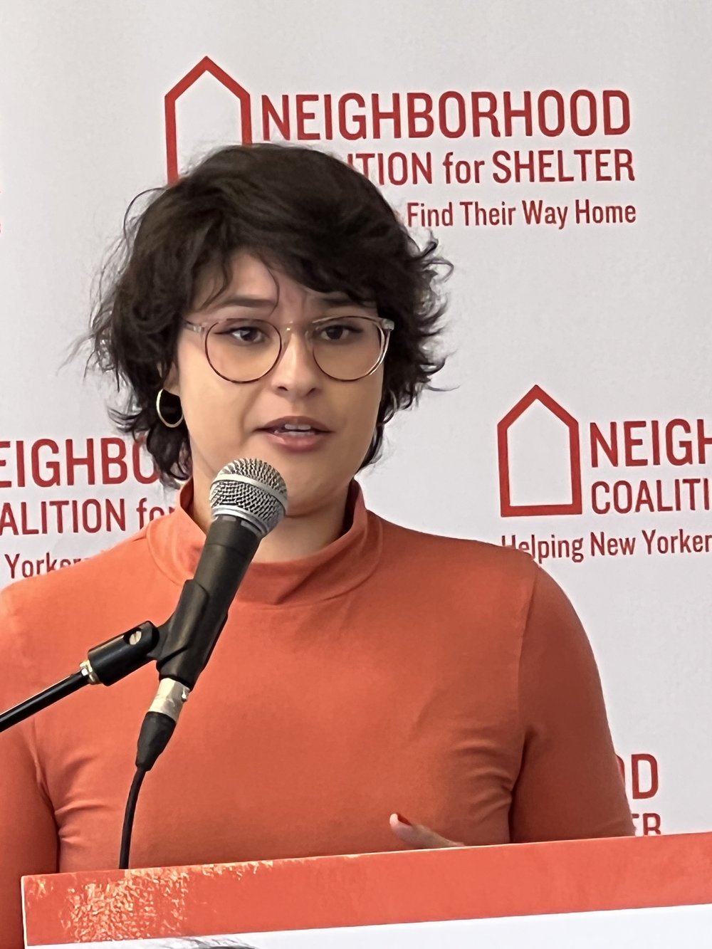 Isabella Marie Zaldaña speaks into a microphone