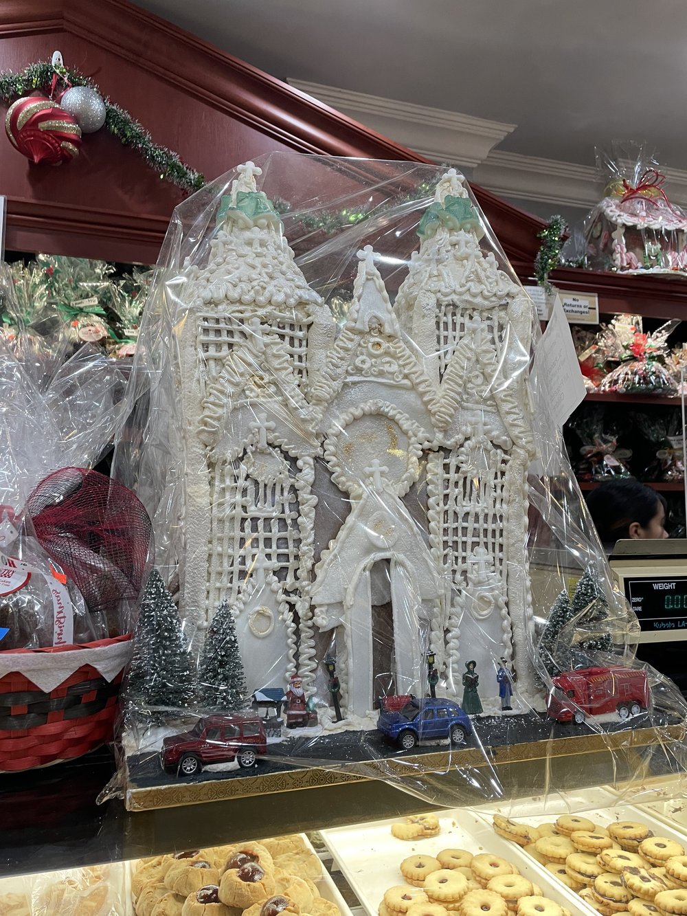 A decorated cake in the shape of a house inside Tasty Pastry Shoppe in Dyker Heights.