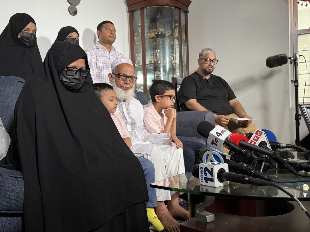 A photo of Det. Islam’s father Mohammed Abdur Rob speaking to reporters alongside Islam’s mother, his two sisters and young sons, ages 4 and 7. A portrait of Islam in uniform was displayed on a coffee table.