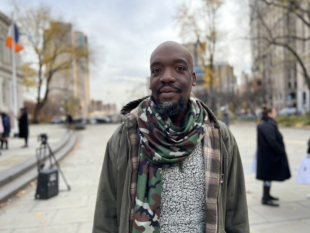 Ibrahim Ayu stands outside City Hall.