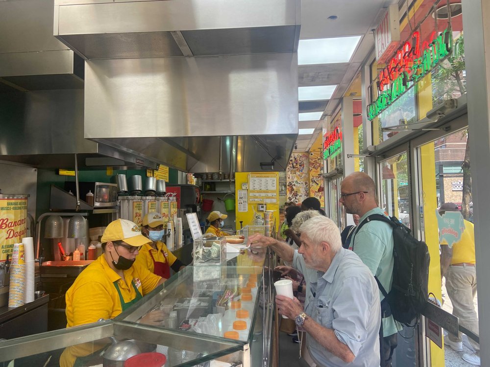 People standing in line in a restaurant.