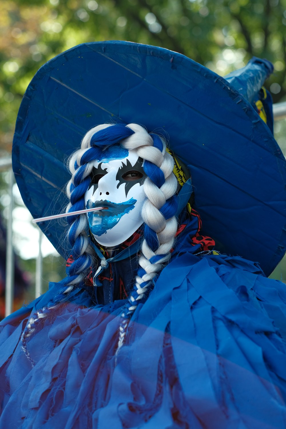 A person in a colorful blue costume.