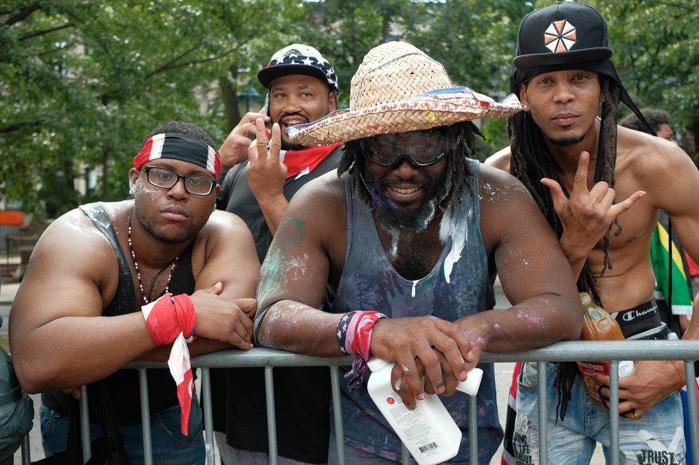 Several men standing behind a barricade.
