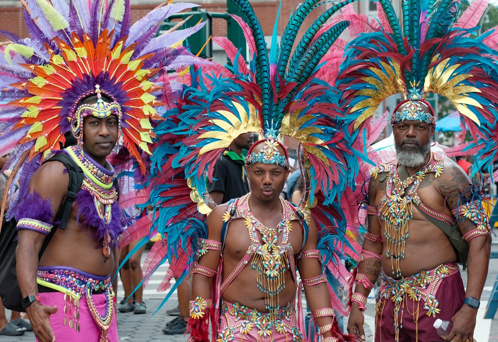 Men in colorful feathered costumes.