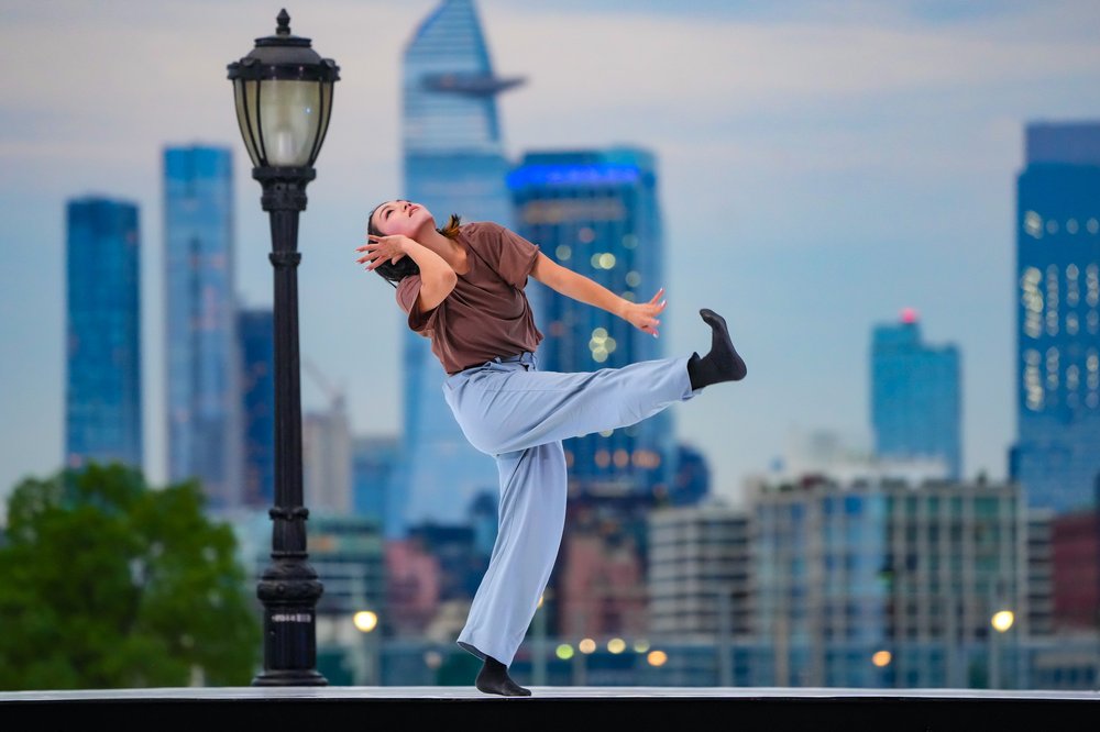 Two dancer couples perform outside.